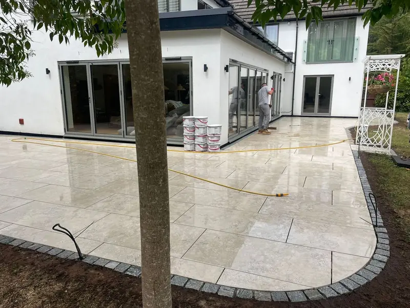 Porcelain patio with granite sett edging at a modern home — SB Constructions