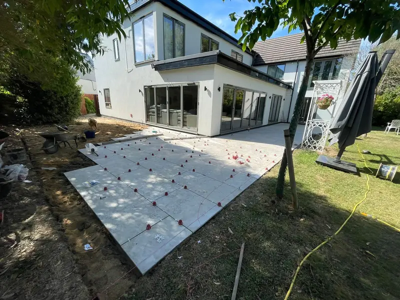Porcelain patio being laid with levelling spacers — SB Constructions