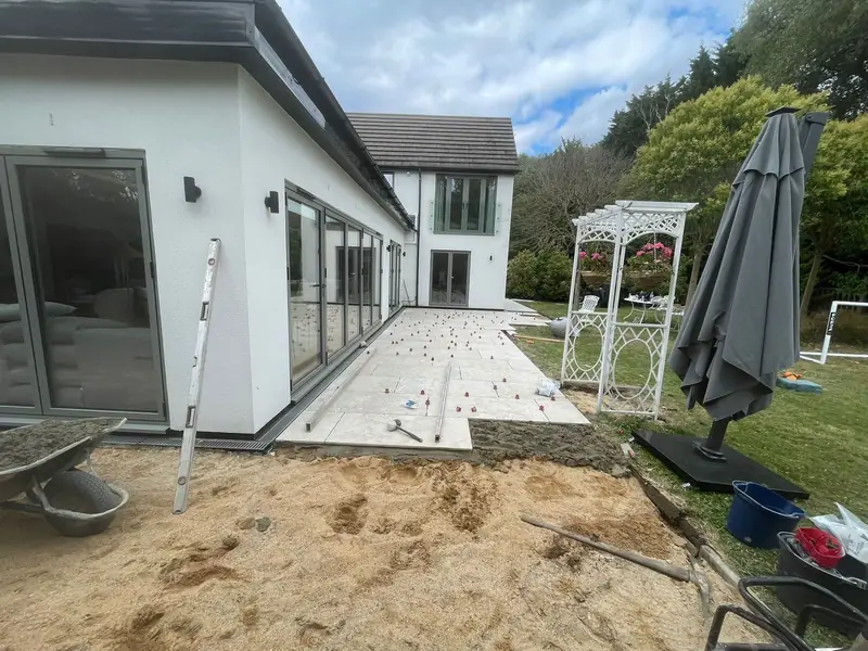 Travertine patio installation in progress — SB Constructions